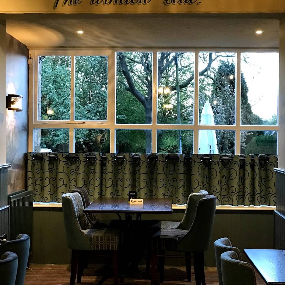 A cosy window table inside The Milbourne Arms